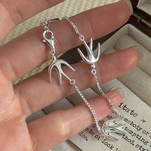 Polished S925 sterling silver swallow bird bracelet with box chain held by hand