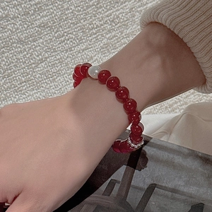 Close-up of S925 silver red agate beaded bracelet with a white pearl on a wrist