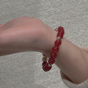 Close-up of S925 sterling silver beaded bracelet with deep red agate stones on wrist