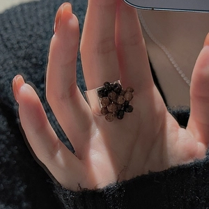 Close-up of wide S925 silver ring with dark brown and black translucent beads