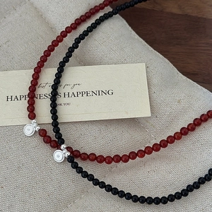 Handmade S925 silver beaded necklace with red agate and a round pendant on linen