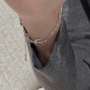 Detailed close-up of S925 sterling silver swallow bird bracelet worn on a wrist