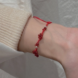 Handwoven red rope bracelet with silver beads and red garnets for women