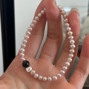 Detailed shot of pink pearls with black and silver accent beads on S925 silver bracelet