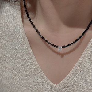 Retro S925 silver necklace with dark brown beads and round embossed pendant on neck