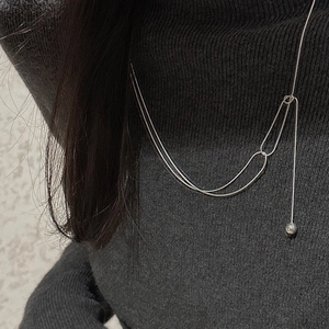 Detail of S925 sterling silver long necklace with geometric links and a polished bead pendant