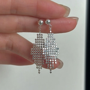 Hand holding S925 sterling silver drop earrings with rhombic metal tassel design