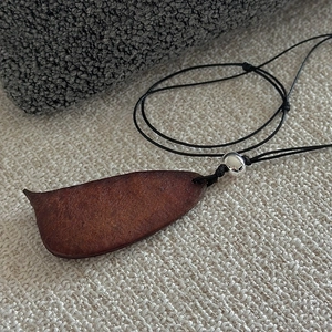 Minimalist S925 silver necklace with a natural wood seed pod pendant on a black cord