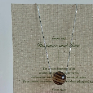 Minimalist S925 silver beaded necklace with round brown striped pendant on card