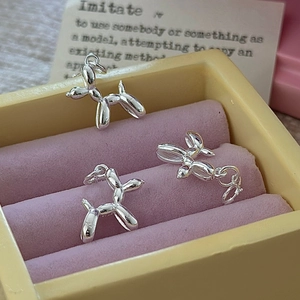 Polished S925 sterling silver balloon dog pendant displayed in a pink velvet jewelry box
