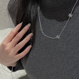 Minimalist S925 sterling silver snowflake flower necklace on a dark sweater