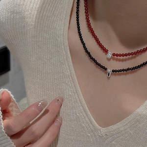 Detail of S925 sterling silver beaded necklaces with garnet and onyx style pendants