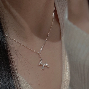 Minimalist S925 sterling silver balloon dog pendant necklace worn by a model