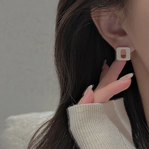Minimalist S925 sterling silver square stud earrings worn by a model in a modern style