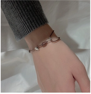 Détail d'un bracelet en corde tressée avec pendentif triangle en argent S925 au poignet