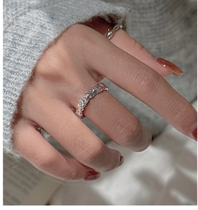 Macro shot of S925 sterling silver ring with molten lava texture on female hand