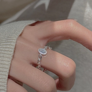 S925 sterling silver chain ring with rectangular clear stone worn on a female hand
