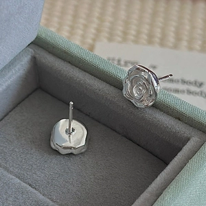 S925 sterling silver rose petal stud earrings presented in a light green jewelry box