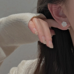 Elegant S925 sterling silver rose flower stud earrings worn by a model in a close-up view
