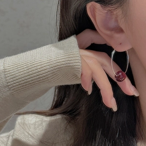 Minimalist S925 silver hoop earrings with red bead accent shown on a model