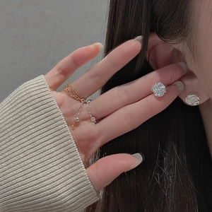 Close-up of S925 silver 3D rose stud earrings and gold-silver mixed chain ring on model