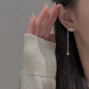Macro detail of S925 sterling silver long tassel earring with unique eye shape design