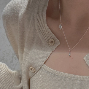 Detail view of S925 sterling silver necklace with teardrop pendant worn by a model