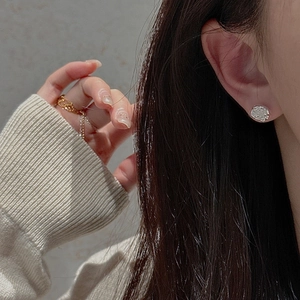 Detailed close-up of S925 sterling silver rose stud earrings worn on ear with elegant petals