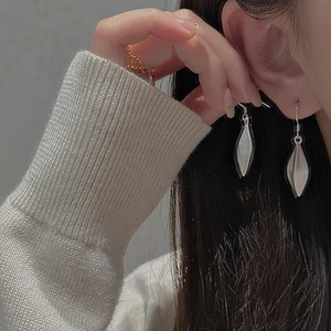 Close-up of S925 sterling silver fruit-shaped earrings with a matte geometric finish
