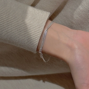 Minimalist S925 sterling silver double layer woven chain bracelet on a soft knit sweater