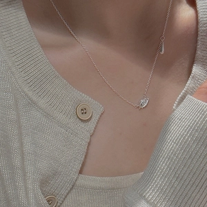 S925 sterling silver evil eye necklace with tassel pendant on model's collarbone