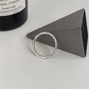 Minimalist S925 sterling silver wave ring with irregular polished finish on a modern backdrop