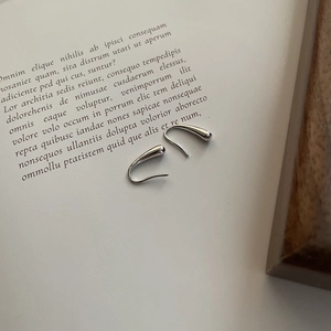 S925 Sterling Silver Teardrop Earrings in Minimalist U-shape Design on a Book Page