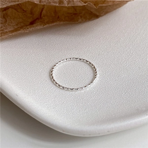 Macro detail of diamond-cut S925 sterling silver ring showing sparkling geometric facets