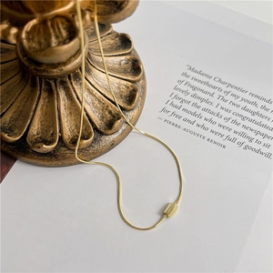 Elegant minimalist S925 silver snake chain necklace with a golden geometric bead pendant