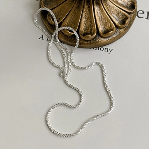 Macro detail of the sparkling texture on the silver s925 clavicle chain necklace