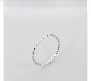 Side view detail of S925 sterling silver ring featuring a textured diamond-cut finish