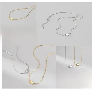 Detail of S925 sterling silver snake chain necklaces in gold and silver finishes