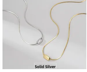Detail of minimalist gold and silver sterling silver rectangular pendant necklaces
