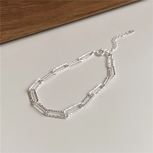 Detailed macro view of S925 sterling silver chain bracelet with hammered texture finish