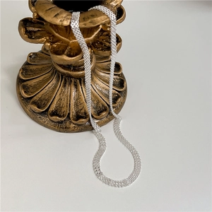 S925 sterling silver woven mesh necklace displayed on a vintage bronze candle holder