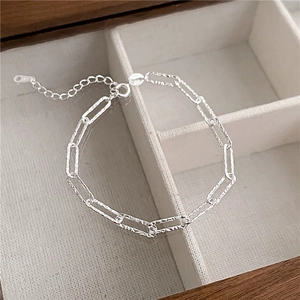Sparkling S925 sterling silver chain bracelet with rectangular links on white velvet