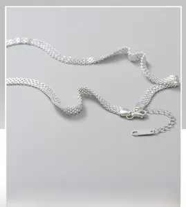 Close-up of S925 sterling silver woven mesh chain with lobster clasp and extension