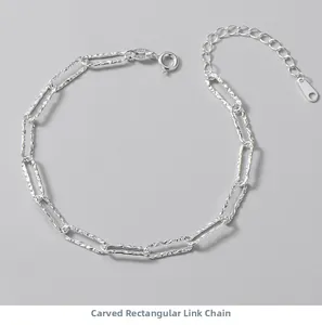Detail of S925 sterling silver paperclip bracelet with textured link patterns and clasp