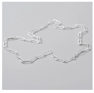 Macro shot of S925 sterling silver paperclip chain with textured links and hallmark