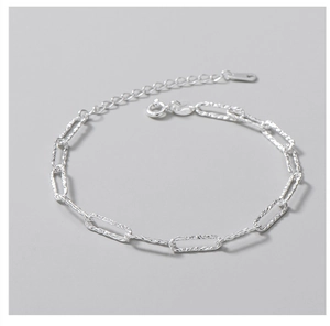 Detail of S925 sterling silver chain bracelet with rectangular links and lobster clasp