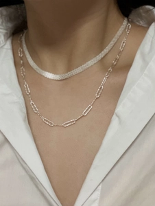 Close-up of stacked S925 sterling silver woven mesh chain and paperclip link necklace