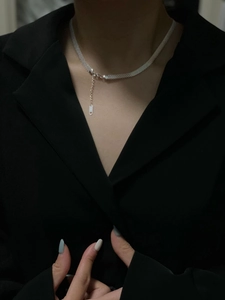 Detail of S925 sterling silver woven choker necklace with extension chain on model