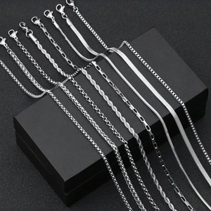 Detailed collection of seven polished silver stainless steel chain styles on a black gift box