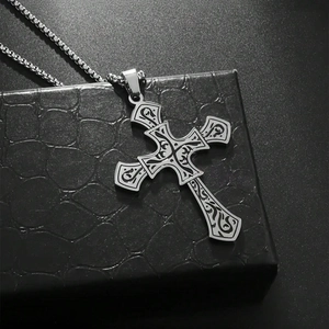 Vintage titanium steel cross necklace with scroll engraving on a black leather jewelry box